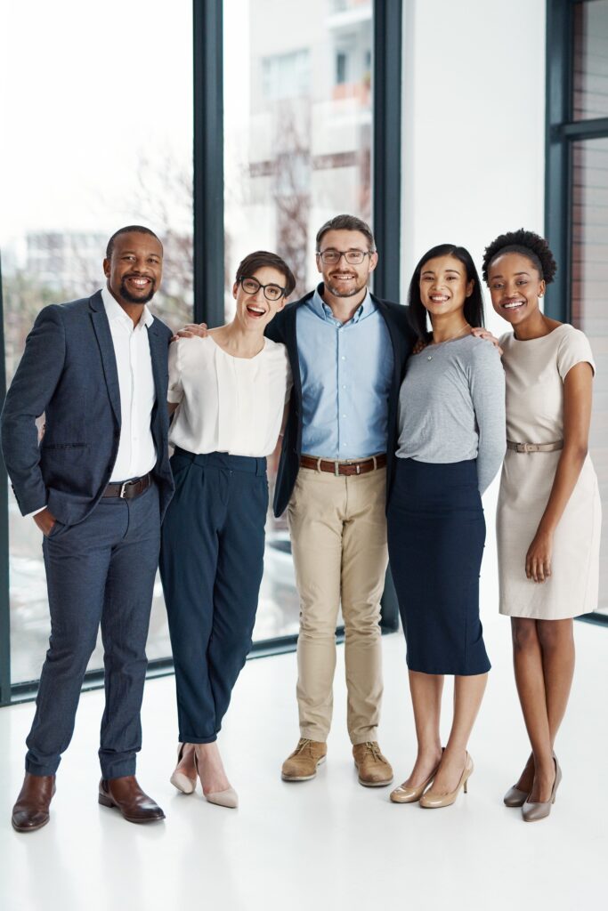 Portrait of a diverse team of professionals standing together in an office