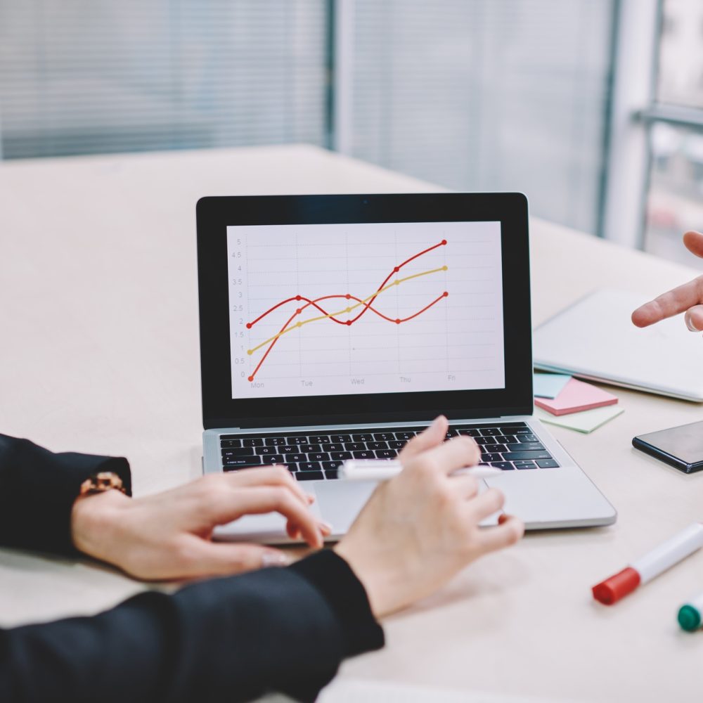 Colleagues discussing financial data in office